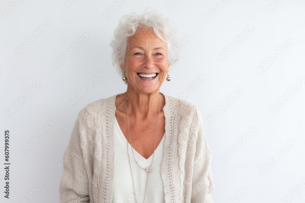 Portrait of a happy senior woman smiling at the camera against white background
