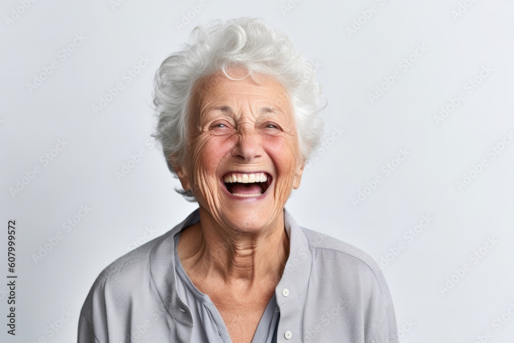Portrait of a happy senior woman laughing on white background with copy space Portrait of a happy senior woman laughing on white background with copy space