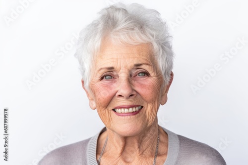 Portrait of a smiling senior woman on a white background. Looking at camera.
