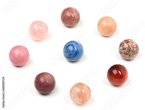 A lone blue marble surrounded by a ring of multi-tonal red marbles.