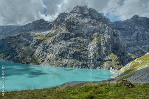View of the Limmernsee dam in the canton of Glarus. Hiking high above the mountain lake in the Alps. Limmernsee Lake, Glarus, Switzerland