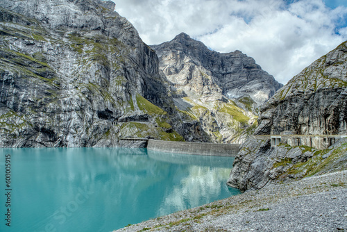 Fototapeta Naklejka Na Ścianę i Meble -  View of the Limmernsee dam in the canton of Glarus. Hiking high above the mountain lake in the Alps. Limmernsee Lake, Glarus, Switzerland