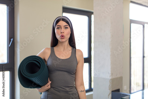 pretty young woman feeling extremely shocked and surprised. yoga concept © kues1