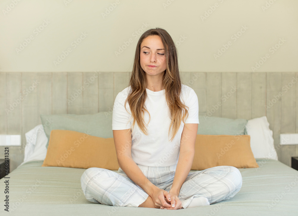 pretty woman smiling and looking with a happy confident expression. nightwear and bedroom concept pretty woman smiling and looking with a happy confident expression. nightwear and bedroom concept
