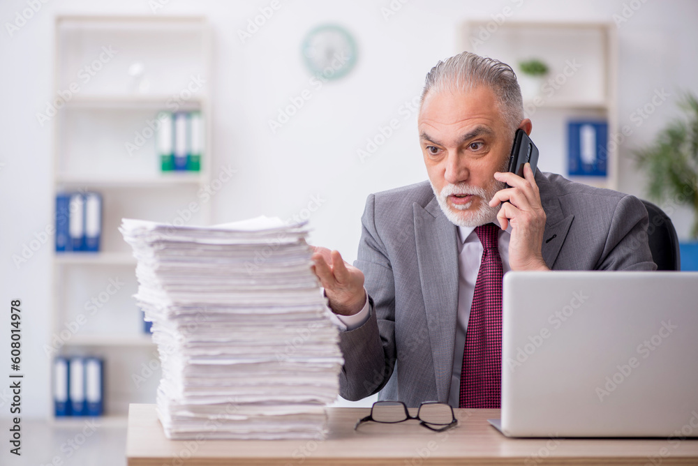 Old male employee and too much work in the office Old male employee and too much work in the office