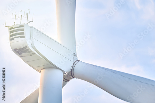Close-up low angle view of wind turbine against blue sky