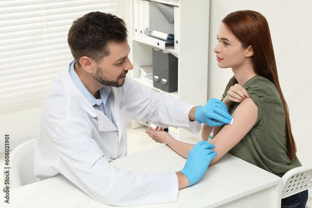 Fototapeta premium Doctor giving hepatitis vaccine to patient in clinic