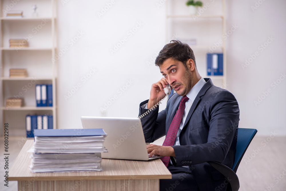 Young male employee working in the office Young male employee working in the office