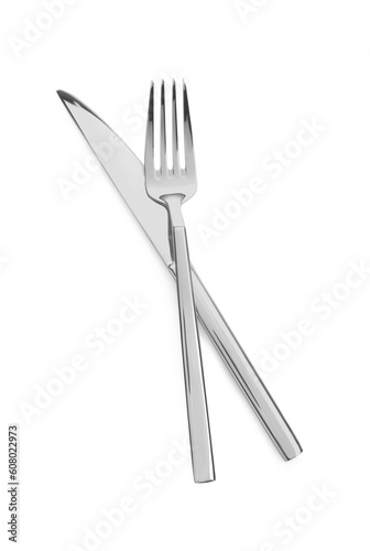 Fork and knife isolated on white, top view. Stylish shiny cutlery set