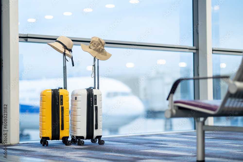 Two suitcases in an empty airport hall, traveler cases in the departure airport terminal waiting for the area, vacation concept, blank space for text message or design Two suitcases in an empty airport hall, traveler cases in the departure airport terminal waiting for the area, vacation concept, blank space for text message or design