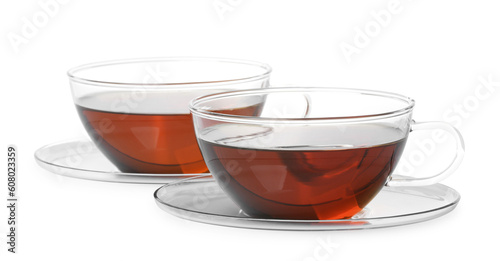 Glass cups of hot aromatic tea on white background