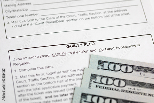 Traffic ticket form and cash money. Traffic citation, fine and law concept.