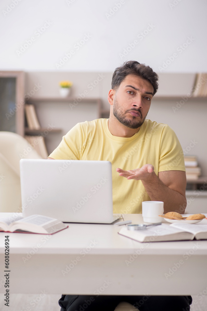 Young male student studying at home Young male student studying at home