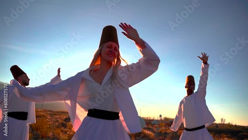 Dervish dance performed against the backdrop of nomads' yurts at sunset