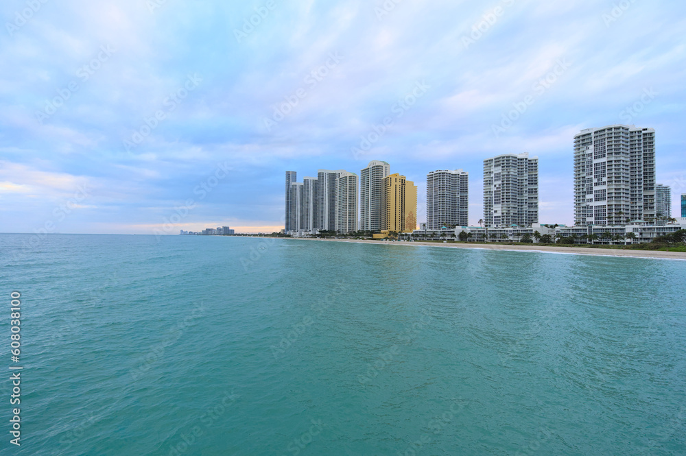 View of Sunny Isles Beach from the pier during cloudy winter eveninf (Florida, USA) View of Sunny Isles Beach from the pier during cloudy winter eveninf (Florida, USA)