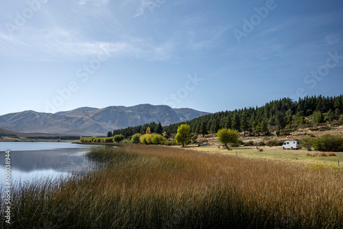 View of Laguna Zeta, with. reeds in the foreground and mountains behind and a motorhome on the side, in Esquel, Chubut, Argentine Patagonia. photo