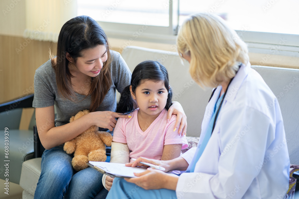 Pediatrician is closely caring and asking about sick girls symptoms, health concepts and child care. Pediatrician is closely caring and asking about sick girls symptoms, health concepts and child care.