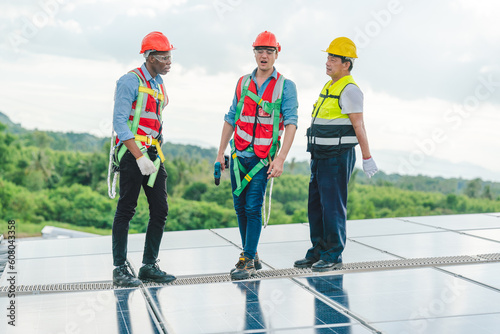 Wallpaper Mural African American engineer maintaining solar cell panels on factory building rooftop. Technician working outdoor on ecological solar farm construction. Renewable clean energy technology concept Torontodigital.ca