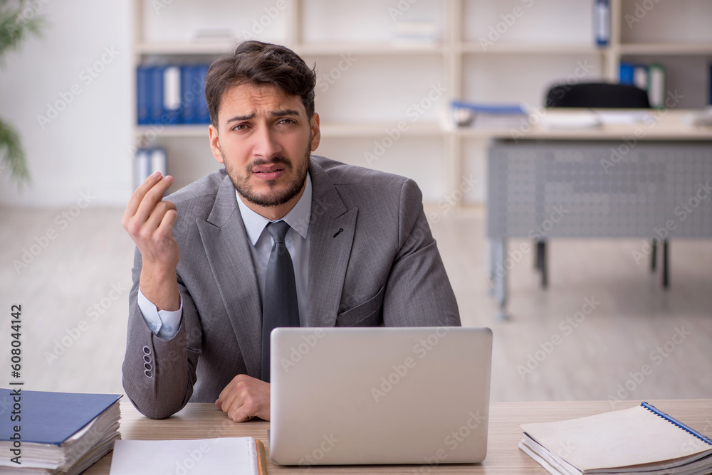 Young male employee working in the office Young male employee working in the office