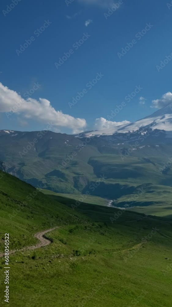 Beautiful view of Mount Elbrus and clouds before sunset, North Caucasus mountains, Russia, timelapse. Vertical video Beautiful view of Mount Elbrus and clouds before sunset, North Caucasus mountains, Russia, timelapse. Vertical video