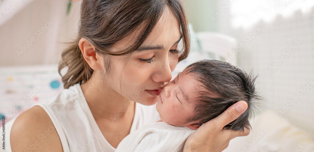 happy loving family. mother playing with her baby hugging in the bedroom , portrait of asian mother playing with newborn baby, health care family love together. asian girl lifestyle.. happy loving family. mother playing with her baby hugging in the bedroom , portrait of asian mother playing with newborn baby, health care family love together. asian girl lifestyle..
