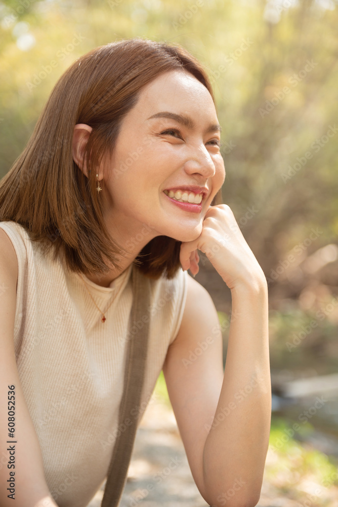 Woman smiling with perfect smile and white teeth in a park and looking at camera, Portrait of beautiful woman smiling and looking away at park during sunset. Happy cheerful girl laughing closeup. Woman smiling with perfect smile and white teeth in a park and looking at camera, Portrait of beautiful woman smiling and looking away at park during sunset. Happy cheerful girl laughing closeup.