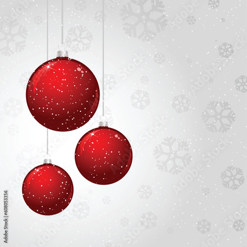 Hanging Christmas baubles on a silver snowflake background