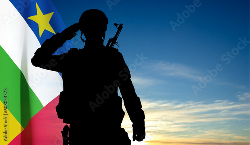 Silhouette of a saluting soldier with Central African Republic flag on background of sky. EPS10 vector