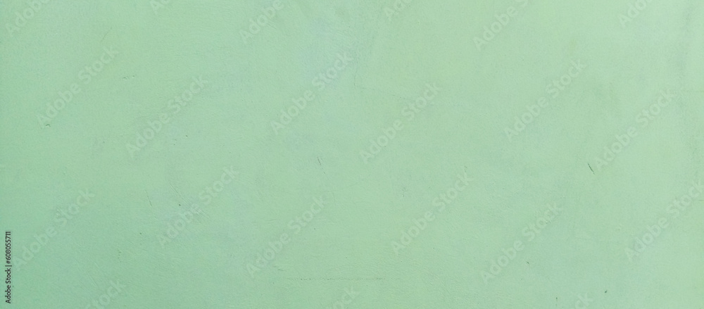 The texture of the green cement wall against a green background, taken at close range The texture of the green cement wall against a green background, taken at close range