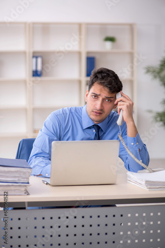 Young male employee working in the office