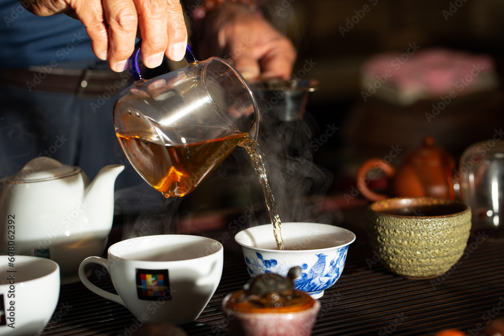pouring tea into a teacup pouring tea into a teacup