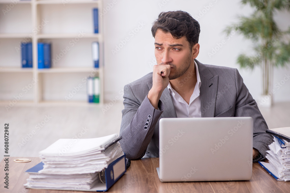 Young male employee working in the office Young male employee working in the office