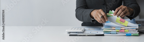 copy space, banner, panorama Businesswoman working in piles of papers looking for marketing and financial data reports on desk, business report papers, folders, folders to prepare meeting in office.