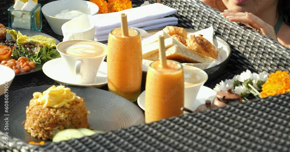 Close up shot of healthy floating breakfast with coffee, smoothies, nasi goreng and bread with croissants and scrambled eggs. Luxury spa hotel with beautiful pool in Bali Indonesia Close up shot of healthy floating breakfast with coffee, smoothies, nasi goreng and bread with croissants and scrambled eggs. Luxury spa hotel with beautiful pool in Bali Indonesia
