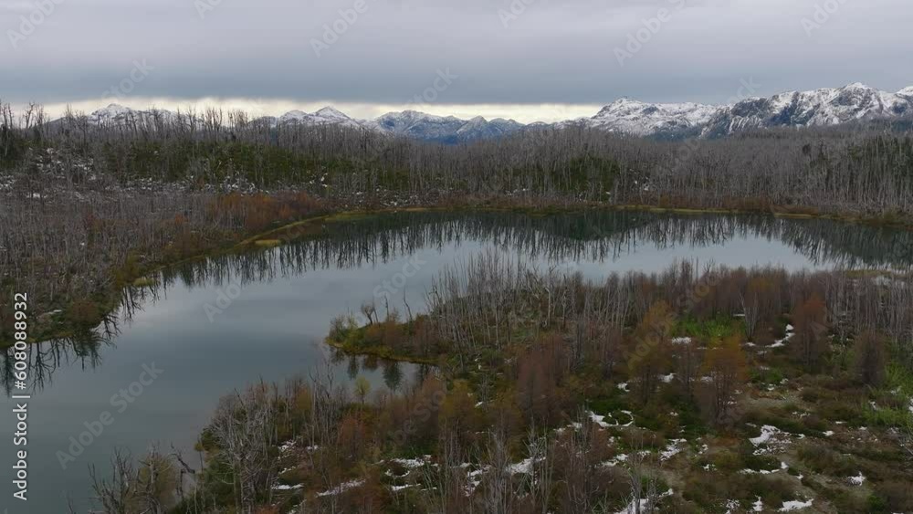 Aerial Dolly View Of pond With View Of Cordón Caulle volcanic complex Covered With Forest Tree Landscape. Dolly Forward Aerial Dolly View Of pond With View Of Cordón Caulle volcanic complex Covered With Forest Tree Landscape. Dolly Forward