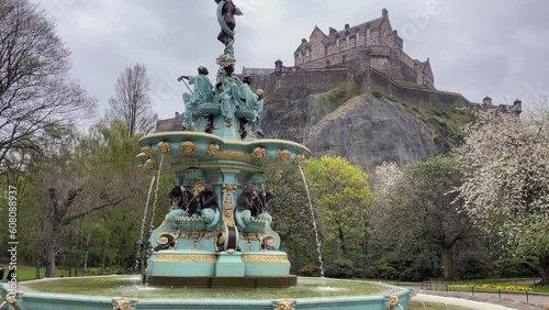 Wide view of Ross fountain on an overcast day in Princes Street Gardens in Edinburgh, Scotland, UK. Panning up the fountain to show Edinburgh Castle. photo