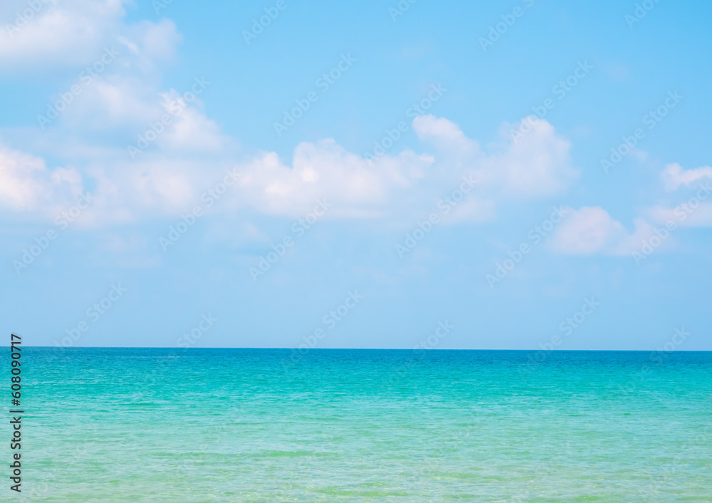 Bright seascape background on sunny day. Summer background with tropical scene, clear sea water, white cloud and open blue sky on sunshine day, summertimes scenery, holiday vacation poster concepts.