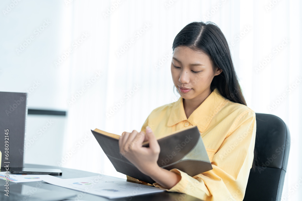 beautiful girl sitting on pc desktop holding pen writing notes home office at home beautiful girl sitting on pc desktop holding pen writing notes home office at home