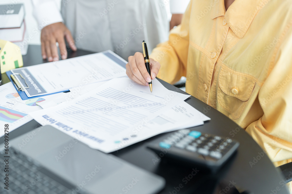 Fototapeta premium Salesmen are letting the male customers sign the sales contract, Asian women and couple are doing business in the office, Business concept and contract signing