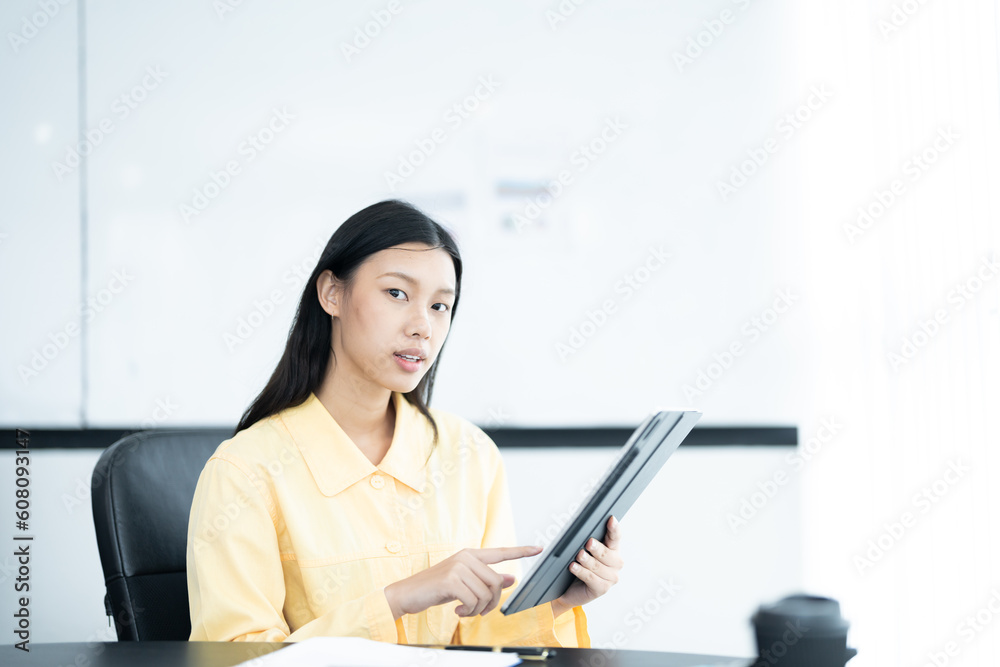 Confident businesswoman holding tablet and smiling at the camera, in meeting room on white background. Confident businesswoman holding tablet and smiling at the camera, in meeting room on white background.