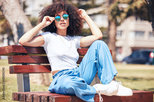 фотографія Fashion, bench and woman with sunglasses, portrait and summer with stylish clothes, trendy and gen z