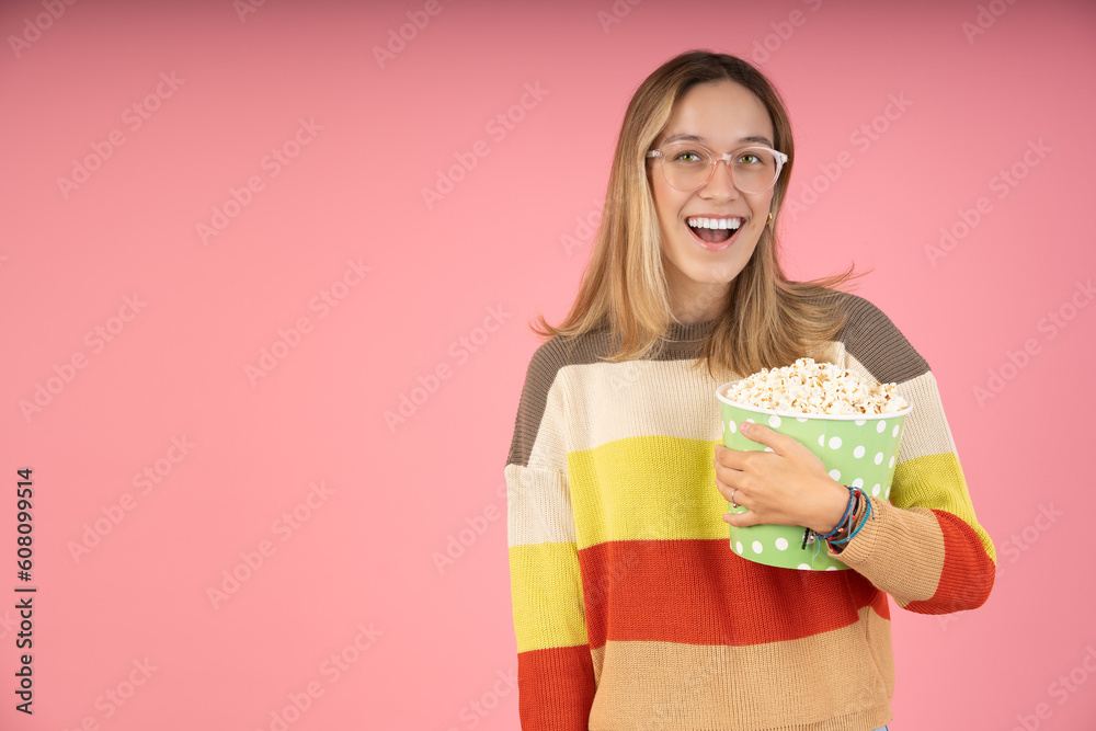 Young woman holding popcorn to watch the movie Young woman holding popcorn to watch the movie