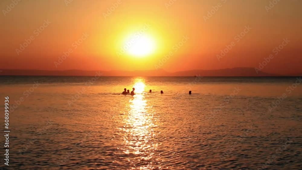 Wide view silhouettes of people enjoying and having fun swimming in Koh Tonsay or Rabbit Island in Cambodia Wide view silhouettes of people enjoying and having fun swimming in Koh Tonsay or Rabbit Island in Cambodia