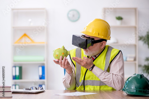 Old male architect enjoying virtual glasses at workplace