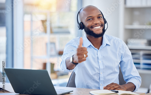 Man at callcenter, thumbs up in portrait and contact us, communication of support and agreement emoji. CRM, customer service and tech, male agent with headset and smile, success and yes hand gesture