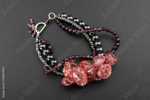 Pink gemstone beads bracelet, unique handmade jewelry background, promotional photo for an online jewellery store 