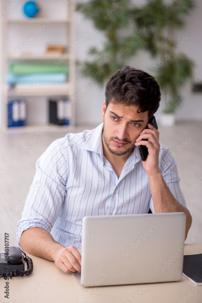 Young male employee working in the office
