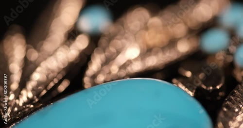 A macro shot of a blue gemstone showcases its exquisite and intricate details, unveiling a world of beauty within. The close-up view reveals the mesmerizing patterns, textures, and color 