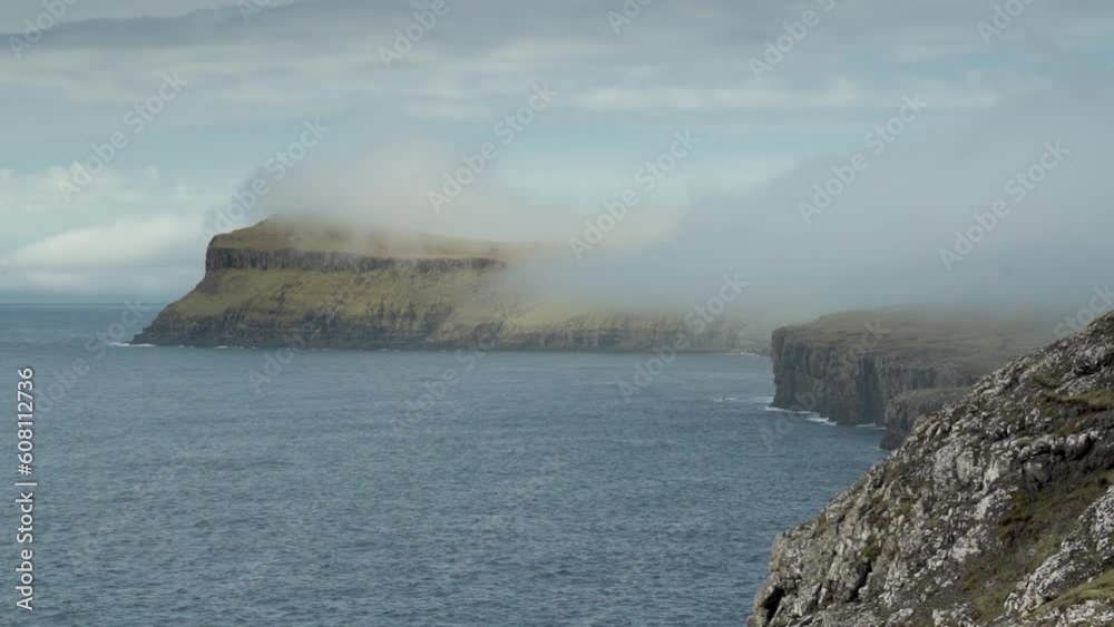 Foggy Clouds Moving Over High Cliffs Of Sandoy In Faroe Islands, Denmark. Timelapse Foggy Clouds Moving Over High Cliffs Of Sandoy In Faroe Islands, Denmark. Timelapse