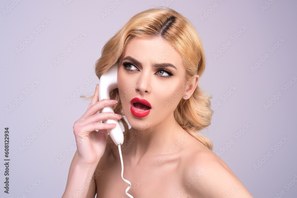 Blonde woman talking on retro telephone. Retro landline telephone